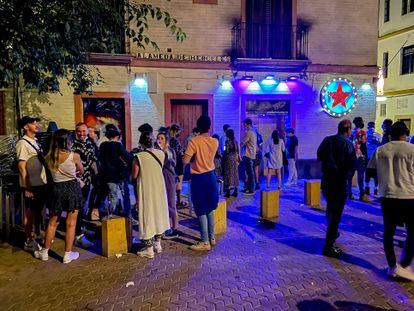 A line of people waiting outside a nightclub in Seville.