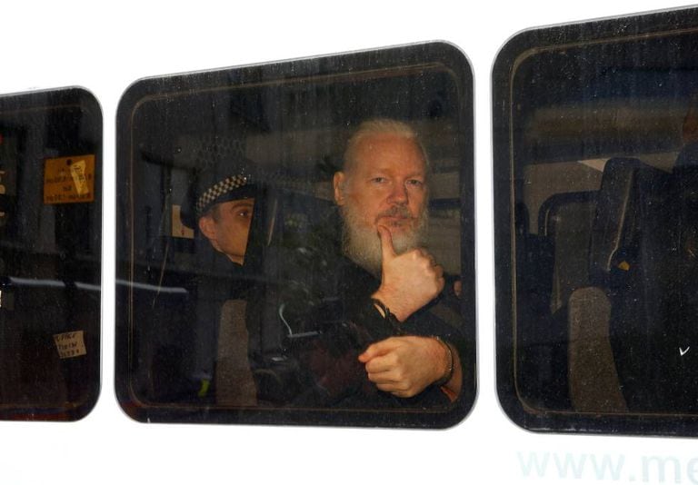 Julian Assange inside a police van after his arrest on April 11.