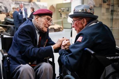 World War II veteran Britain's Bill Gladden, left, speaks with U.S WWII veteran Jack M. Larson in the Pegasus Bridge memorial in Benouville, Normandy