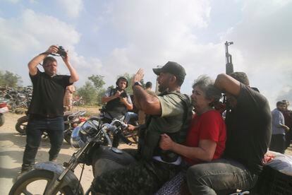 An Israeli woman is taken away by motorcycle after being kidnapped from the Kfar Azza kibbutz by Palestinian militias.
