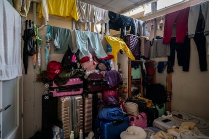 Clothes and suitcases in a Peruvian immigrant family’s room in a basement in Usera. Seven people sleep in the 8.6-square-meter (92.57-square-foot) room. The family is charged €700 ($743.59) a month for the stifling space. A total of 13 other people live in the same basement.