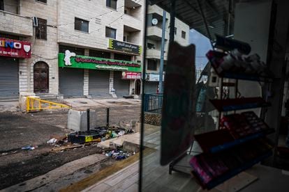 A street in Huwara blocked by the Israeli army, seen from the store run by Karim Ahmed.