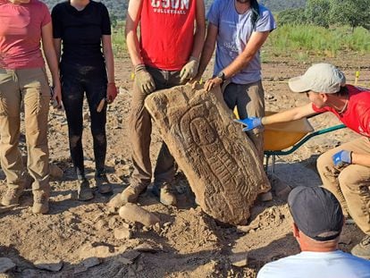 An archaeologist points to the stela featuring the diadem found at Las Capellanías site in Huelva.