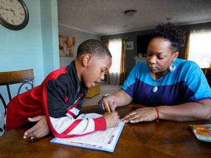 Tamela Ensrud helps her son, Christian, 7, with his homework at their home on Monday, November 21, 2022, in Nashville, Tennessee.