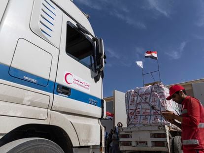Aid convoy trucks are checked as they prepare to cross the Rafah border from the Egyptian side on October 21, 2023, in North Sinai, Egypt.