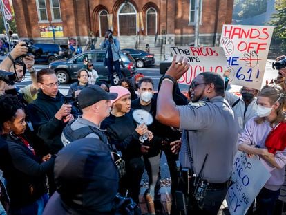 Fulton County Sheriff's deputies speak to organizers, as 'Stop Cop City' demonstrators protest outside the Fulton County Courthouse