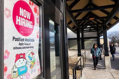 A hiring sign is displayed at a grocery store in Arlington Heights, Ill., on December 27, 2022.