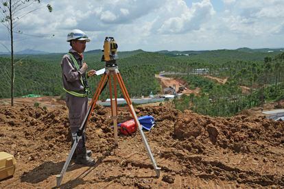 Worker uses his equipment at the construction site of the new capital city in Penajam Paser Utara, East Kalimantan, Indonesia, Wednesday, March 8, 2023.