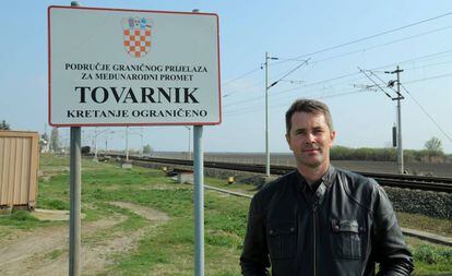 Dubravko Blaskovic, president of the regional council of Vukovar, stands by a symbolic sign in Tovarnik, several meters from the Serbian border.