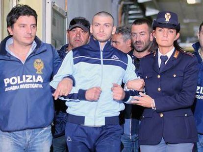 Catello Romano, escorted by policemen, in October 2009 in Naples, in a photo from his thesis.