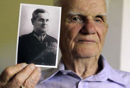 Polish Franciszek Herzog shows a photo of his father, Franciszek Herzog, executed by the Soviets in Katyn in 1940