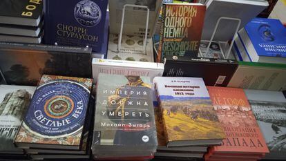 A display at the All Free bookstore with a book by Mikhail Zygar, rated 18+. Above and to the right is ‘Defying Hitler: A Memoir’ by Sebastian Haffner.
