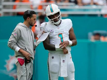 Miami Dolphins quarterback Tua Tagovailoa (1) listens to head coach Mike McDaniel during the second half of an NFL football game against the New York Giants, Sunday, Oct. 8, 2023, in Miami Gardens, Fla.