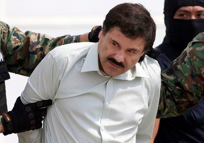 In this Feb. 22, 2014 file photo, Joaquin "El Chapo" Guzman, the head of Mexico's Sinaloa Cartel, is escorted to a helicopter in Mexico City following his capture in the beach resort town of Mazatlan, Mexico.