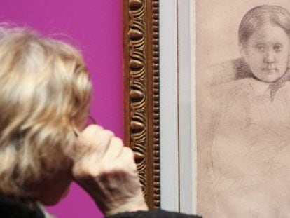 A visitor examines one of the works by Degas at the exhibition in Fundación Canal.