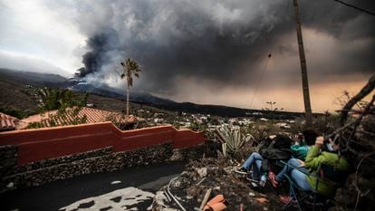 Tourists observing the volcano near the viewpoint of Tajuya, on the island of La Palma.