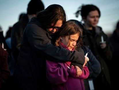 Sarah Tuck prays with her daughter Emmalin Sweeney, 10, during a community vigil held for the people killed during the Covenant School shooting, on March 28, 2023.