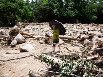 A resident walks amid debris at the site of a landslide caused by heavy rains in Yecheon-gun, Gyeongsangbuk-do province, South Korea, on July 17, 2023.