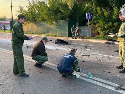 In this handout photo, investigators work on the site of the explosion of a car driven by Daria Dugina outside Moscow.