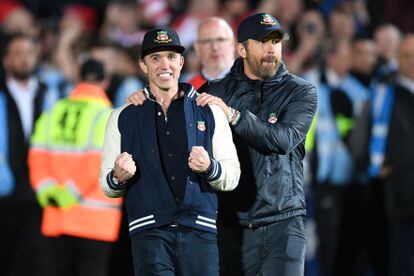 US actor and Wrexham owner Rob McElhenney (L) and US actor and Wrexham owner Ryan Reynolds (R) celebrate on the pitch after the English National League football match between Wrexham and Boreham on April 22, 2023.