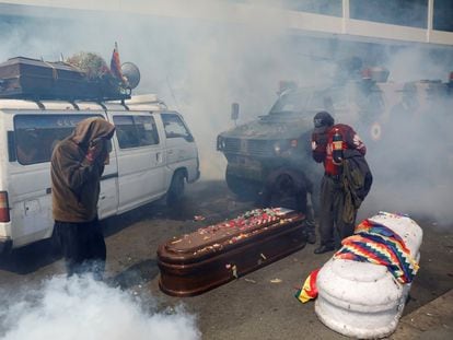 Bolivian security forces fire tear gas at protesters carrying the coffins of those killed during the 2019 massacres.