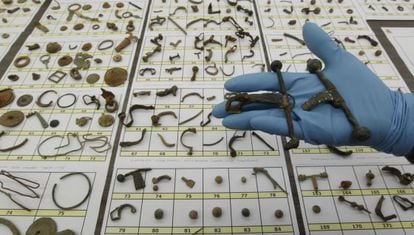 A civil guard holds up some of the archaeological items recovered during so-called "Operation Helmet."