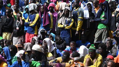 Migrants wait at the port pier before boarding on the military ship 'Cassiopea' to be transferred to other places from the island of Lampedusa, southern Italy, 15 September 2023.