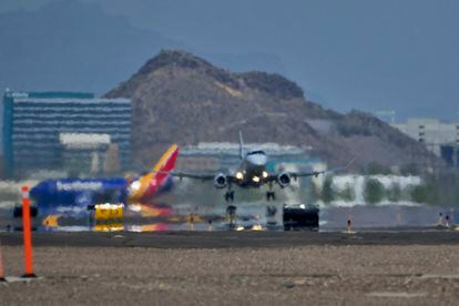 A jet takes flight as heat ripples radiate from the runway, Tuesday, July 25, 2023 at Sky Harbor International Airport, in Phoenix