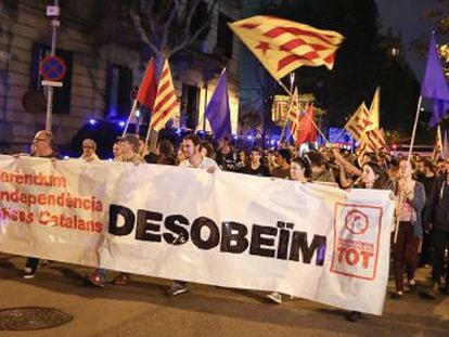 Protestors bear a sign calling for disobedience in Barcelona on Monday.