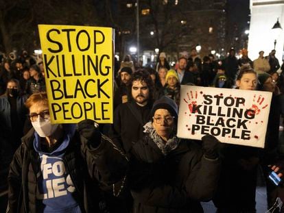 Demonstrators hold signs during a protest in New York City on January 28, 2023, in response to the death of Tyre Nichols, who died after being beaten by Memphis police during a traffic stop.