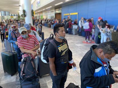 Passengers stand in line at Tijuana International Airport, on December 25, 2022.
