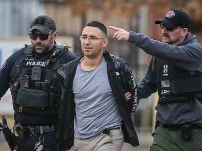Solomon Peña, center, a Republican candidate for New Mexico House District 14, is taken into custody by Albuquerque Police officers, on Monday, in southwest Albuquerque.