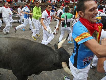 A bull catches one of the runners on Saturday morning.