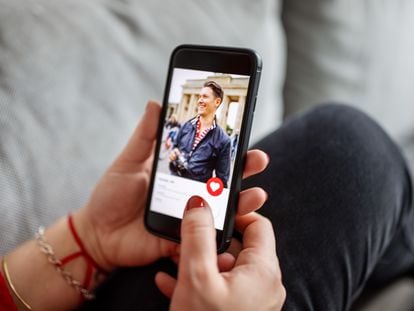 A woman using a dating app on a mobile phone.