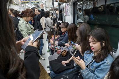 Passengers on a subway in Seoul, South Korea.
