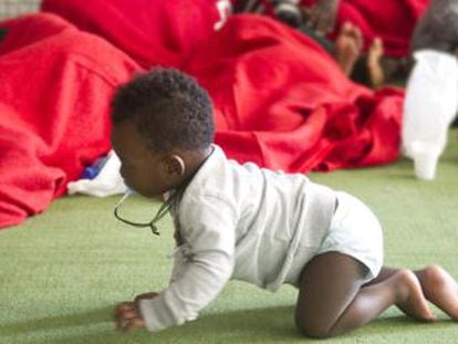 A baby crawls on the floor of a former sports center turned into an immigrant shelter in Tarifa last August.