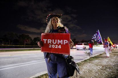 A supporter of former U.S. president Donald Trump attends a gathering outside his Mar-a-Lago resort after hearing news of Trump's indictment by a Manhattan grand jury.