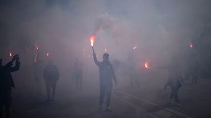 Protesters march with flares during a demonstration in Marseille, southern France, on March 28, 2023.