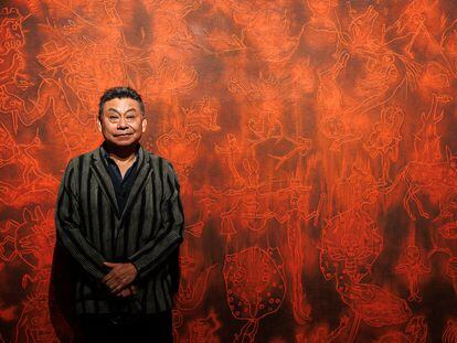 Mexican painter Sergio Hernández poses in front of one of the pieces in his new exhibit, ‘Embers of Oaxaca,’ the artist’s first solo show in the US.