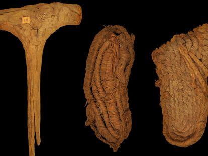 A mallet made of olive wood, alongside two sandals made from esparto grass, recovered from a cave frequented by bats in Granada, Spain.
