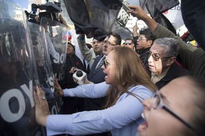 Protestors confront police in Quito.