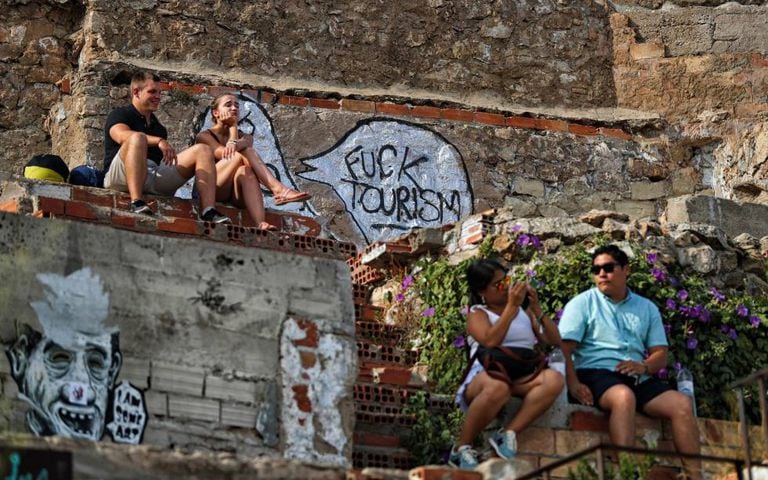 Graffiti attacking tourism in Barcelona at the El Carmel former anti-aircraft batteries on the outskirts of the city.