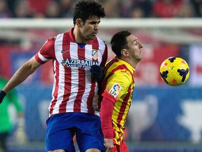 Diego Costa (l) of Atl&eacute;tico Madrid tackles Barcelona&#039;s Lionel Messi during Saturday&#039;s 0-0 tie at the Calder&oacute;n. 