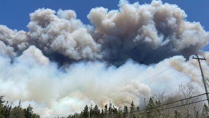 In this May 28, 2023, image courtesy of the Nova Scotia Government in Canada, smoke rises from a wildfire near Barrington Lake in Nova Scotia's Shelburne County.