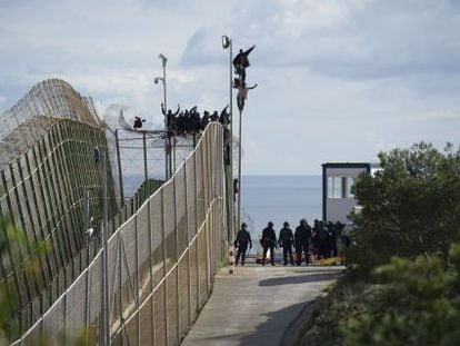 The would-be immigrants were perched on top of the border fence at Melilla for six hours on Thursday.