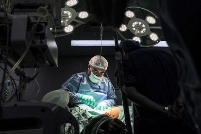 A surgeon operates on a patient in an operating room at the European Hospital in Khan Younis, southern Gaza Strip, December 31.