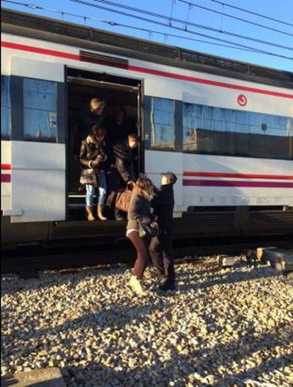 Police help passengers off one of the commuter trains near Atocha.