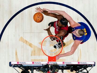 Jimmy Butler grabs a rebound off Nikola Jokic in Game 1 of the NBA Finals.