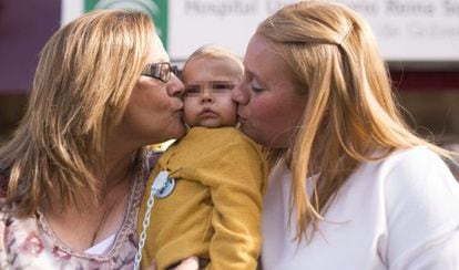 Francisca Fuentes (left), her grandson Juan José and the baby's mother outside the Córdoba hospital where the surgery took place.