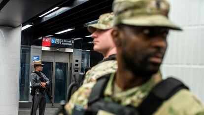 Police and National Guard soldiers patrol a New York subway station, March 7, 2024.